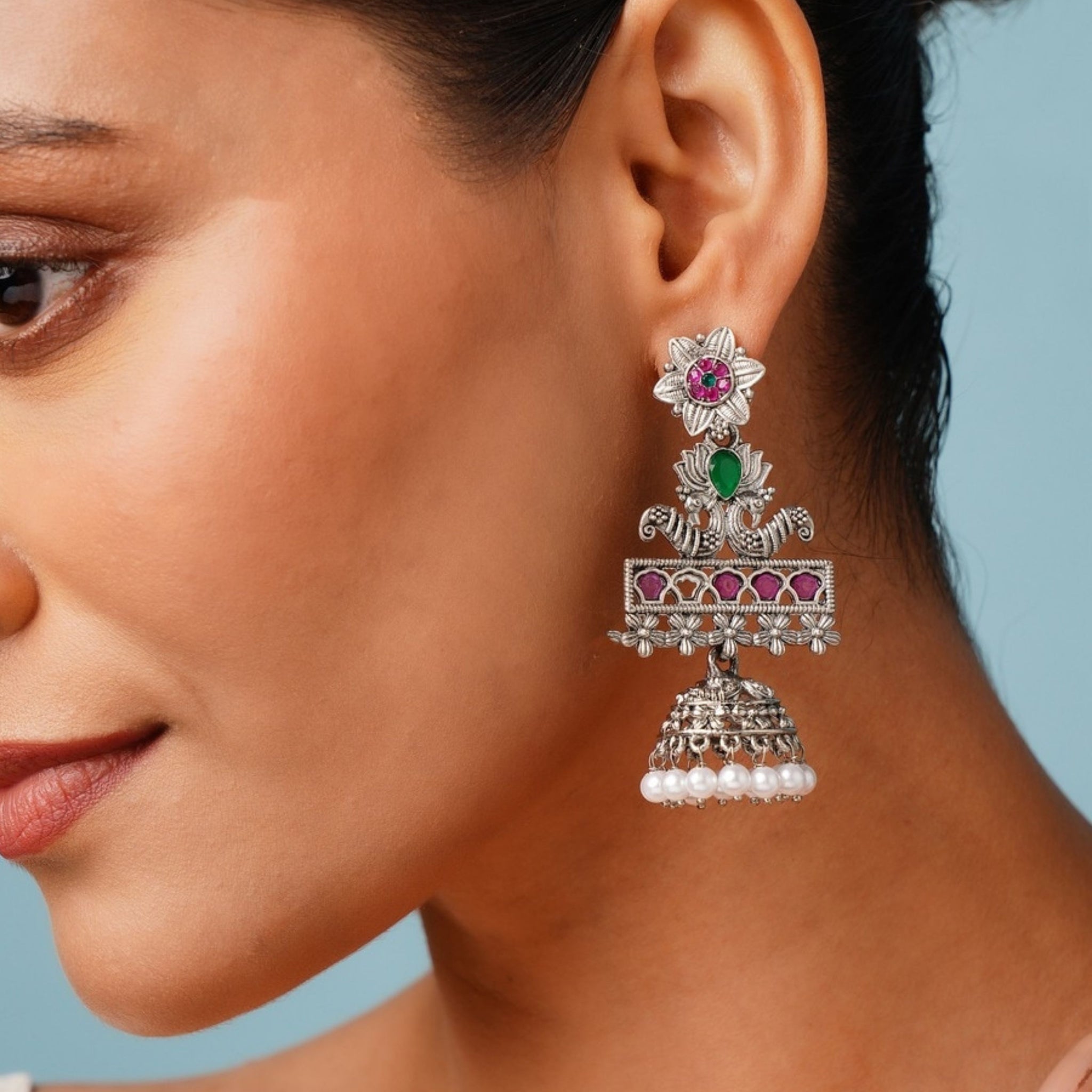 Abdesignsjewellery German Silver Plated Long Peacock Earrings with floral and pearl details worn by model