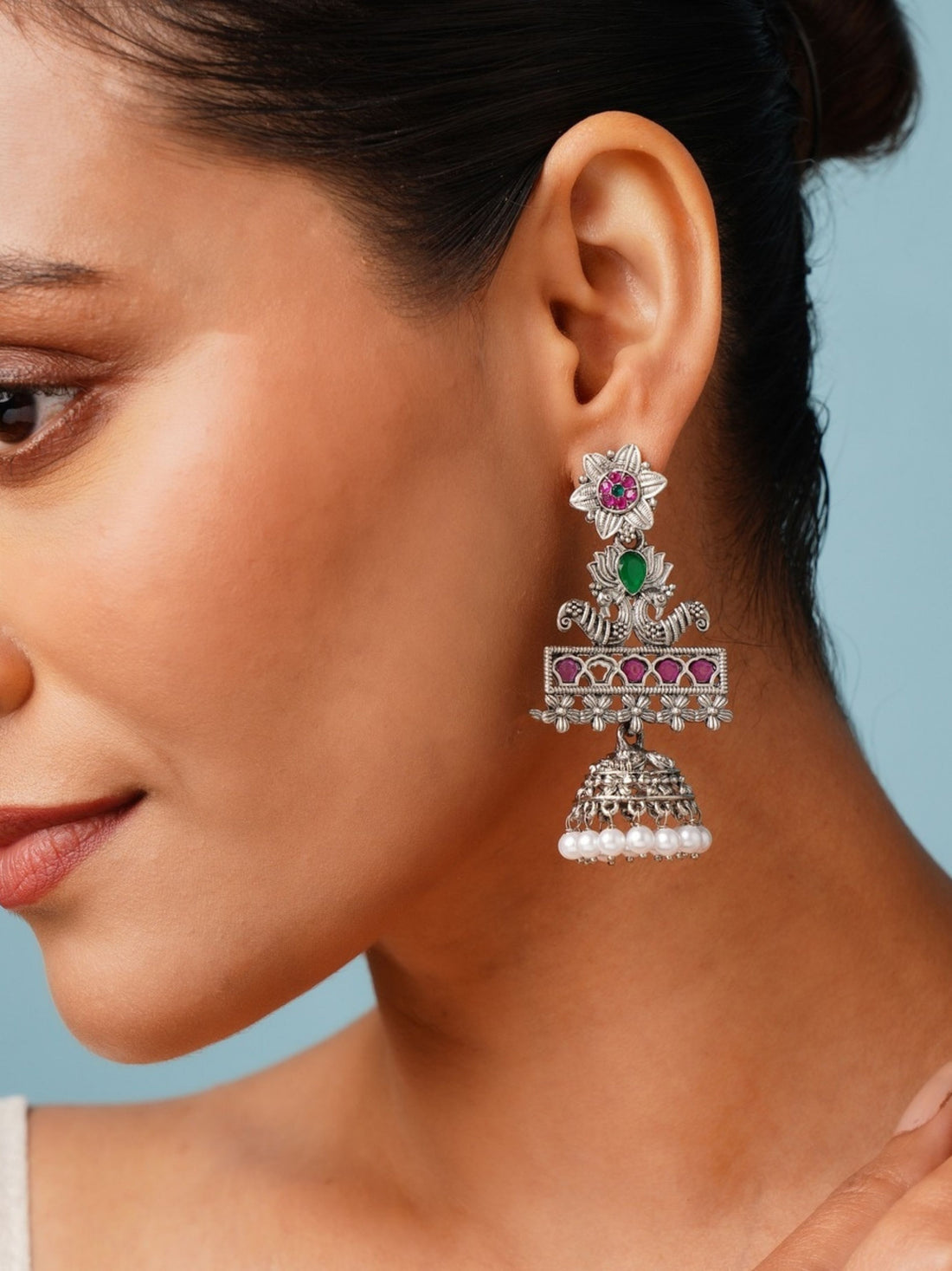 Abdesignsjewellery German Silver Plated Long Peacock Earrings with floral and pearl details worn by model