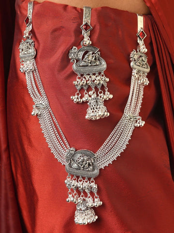 German silver saree juda pin combo with intricate peacock motifs and dangling jhumki tassels on red saree