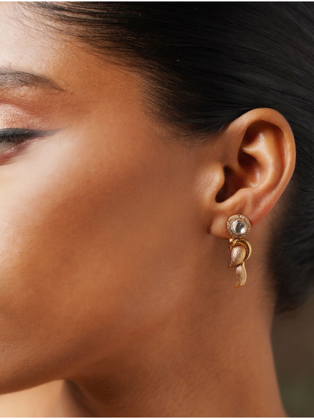 Close-up of Glass Kundan Polki Parrot Studs Earrings worn on a woman's ear showcasing intricate design