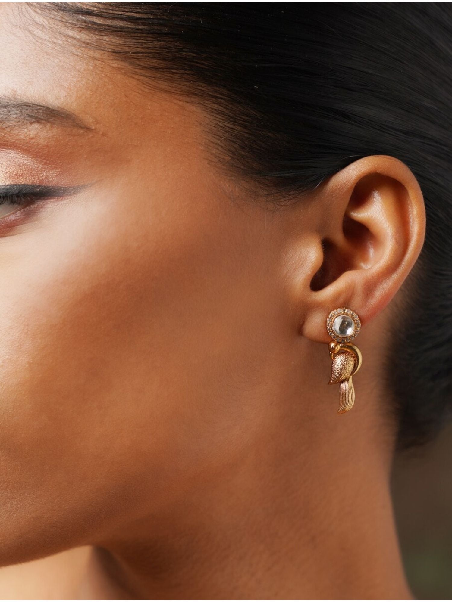 Close-up of Glass Kundan Polki Parrot Studs Earrings worn on a woman's ear showcasing intricate design