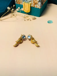 Thumbnail for Gold Glass Kundan Polki Parrot Studs Earrings with clear stones next to decorative jewelry box