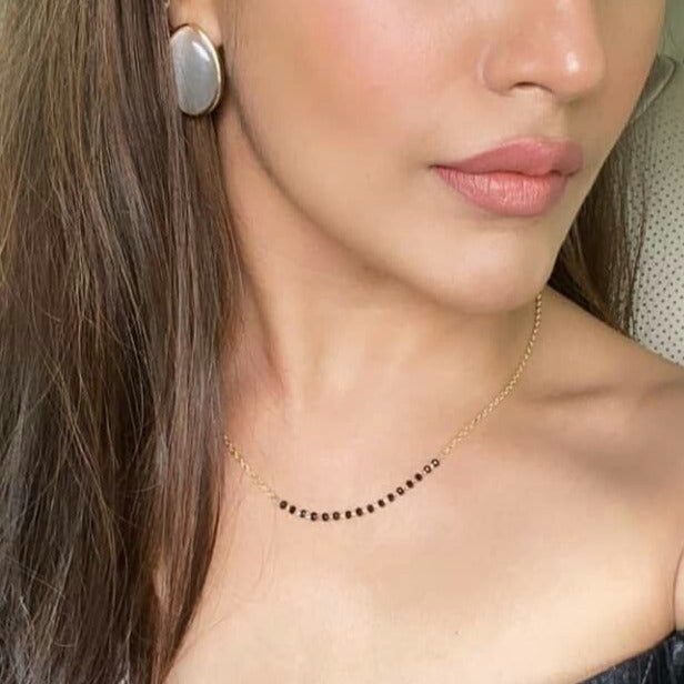 Abdesignsjewellery Gold Plated American Diamond Mangalsutra worn by woman with black beads and delicate chain