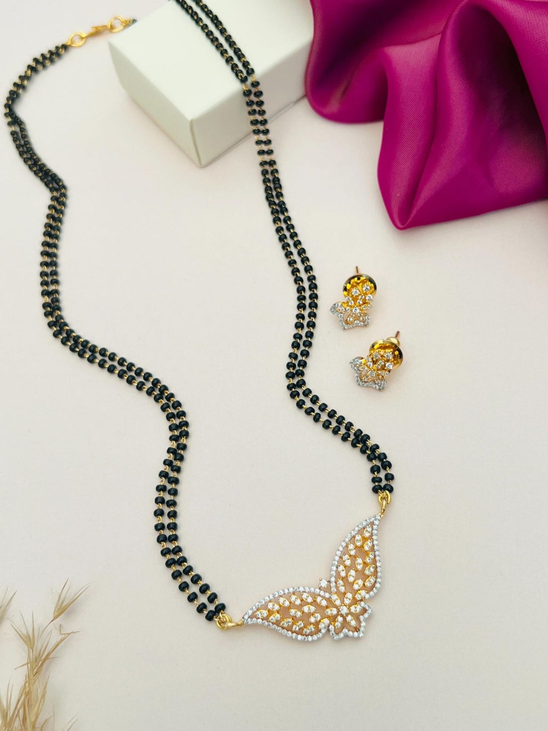 Abdesignsjewellery gold plated American diamond mangalsutra set with butterfly pendant and matching earrings on display