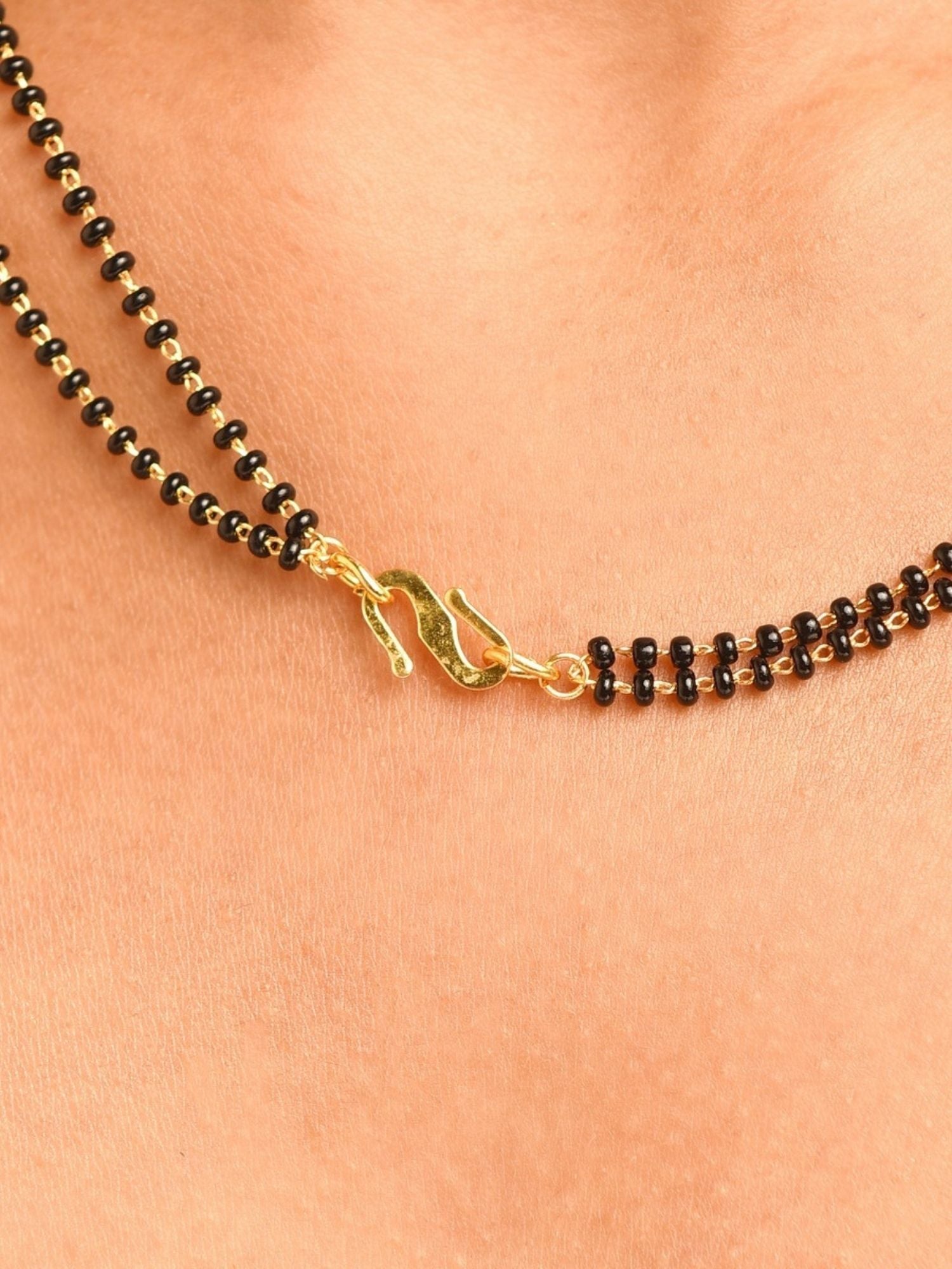 Abdesignsjewellery gold plated American diamond mangalsutra set close up of double black bead chain and gold hook clasp on neck