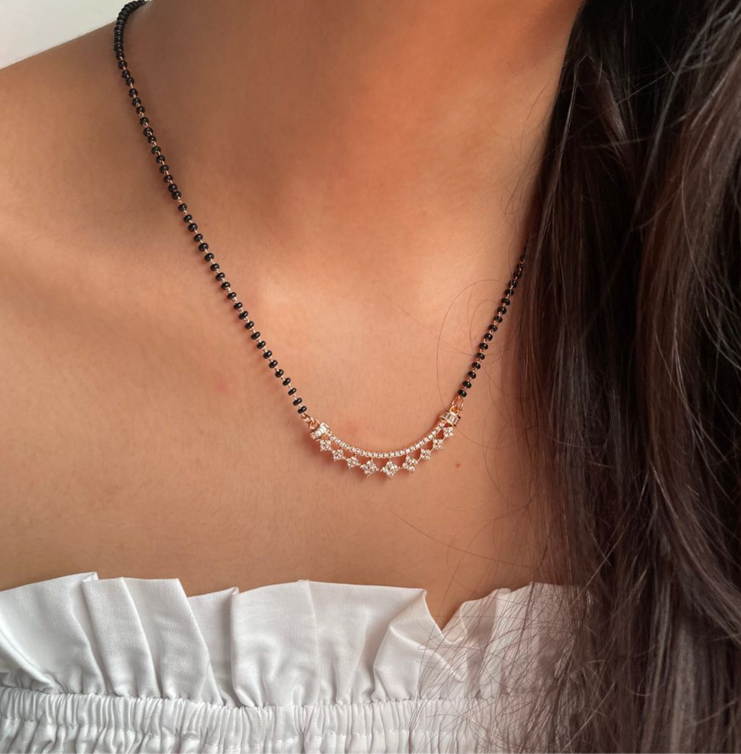 Gold Plated American Diamond Mangalsutra with black beads and delicate pendant worn on neck