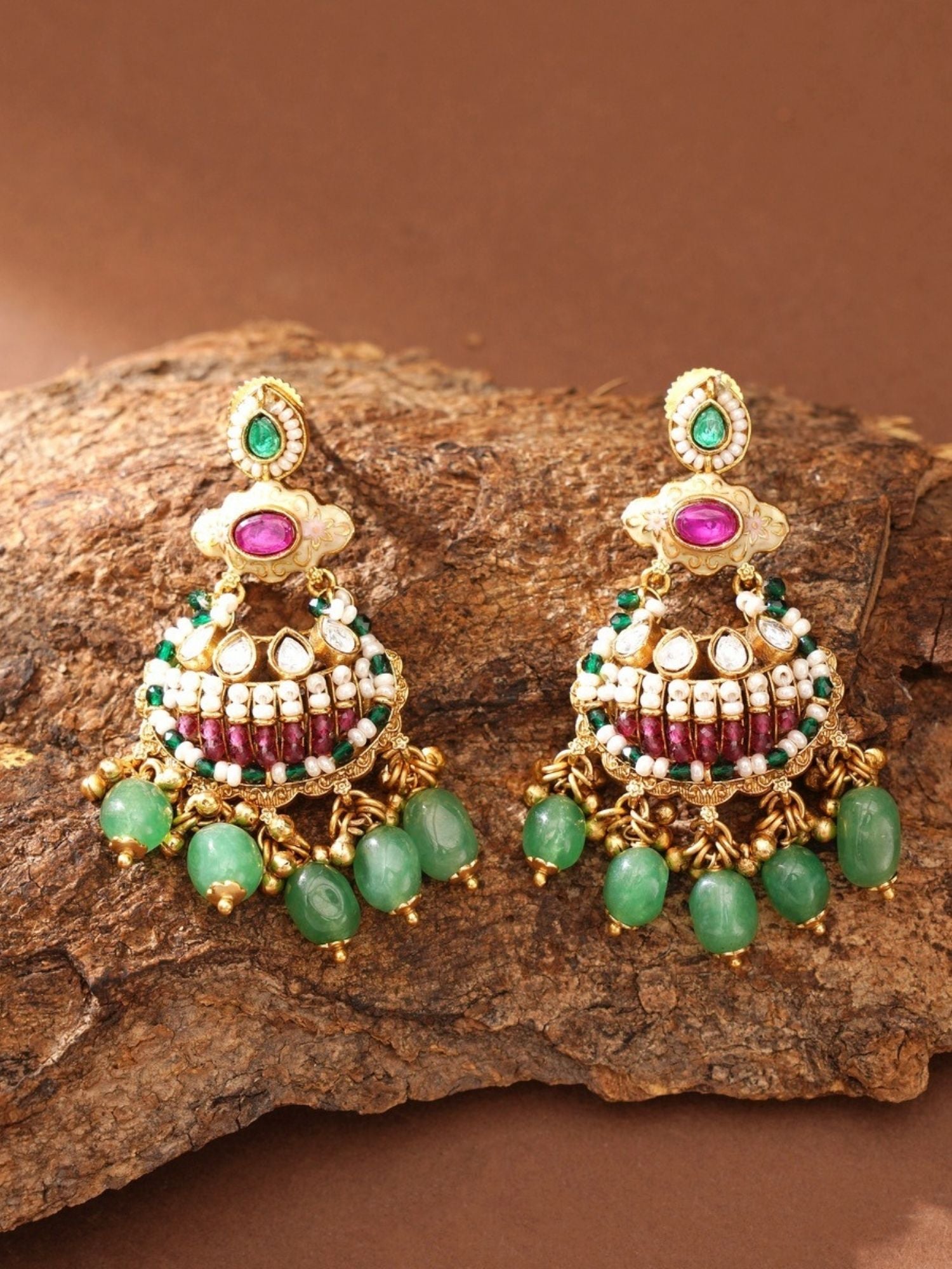 Pair of ornate gold jhumka earrings with green beads and pink stones by Abdesignsjewellery gold plated antique bridal jewellery set