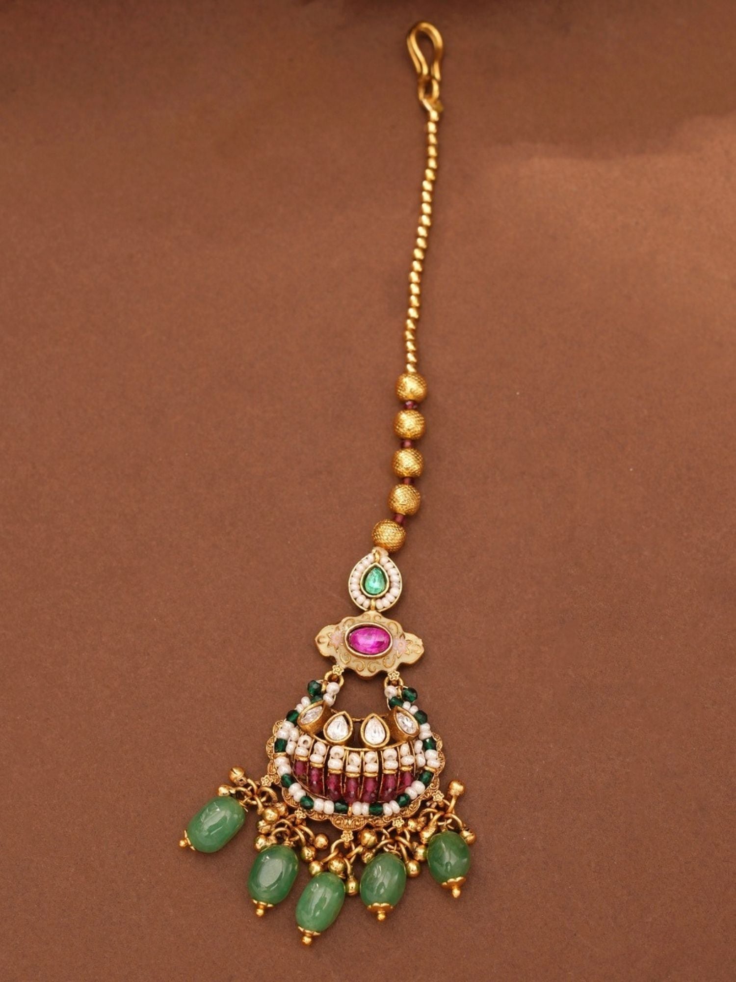 Abdesignsjewellery gold plated antique bridal jewellery set pendant with pink stones and green bead drops on brown background