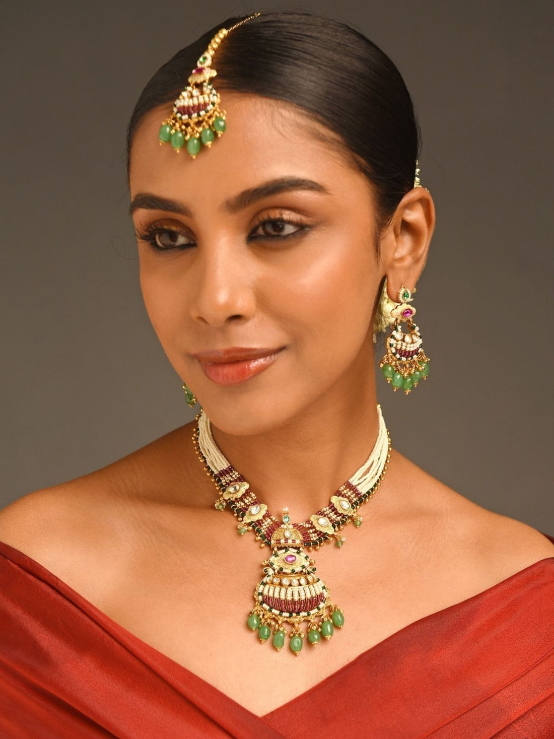 Abdesignsjewellery gold plated antique bridal jewellery set necklace with green stone drops and matching earrings on model