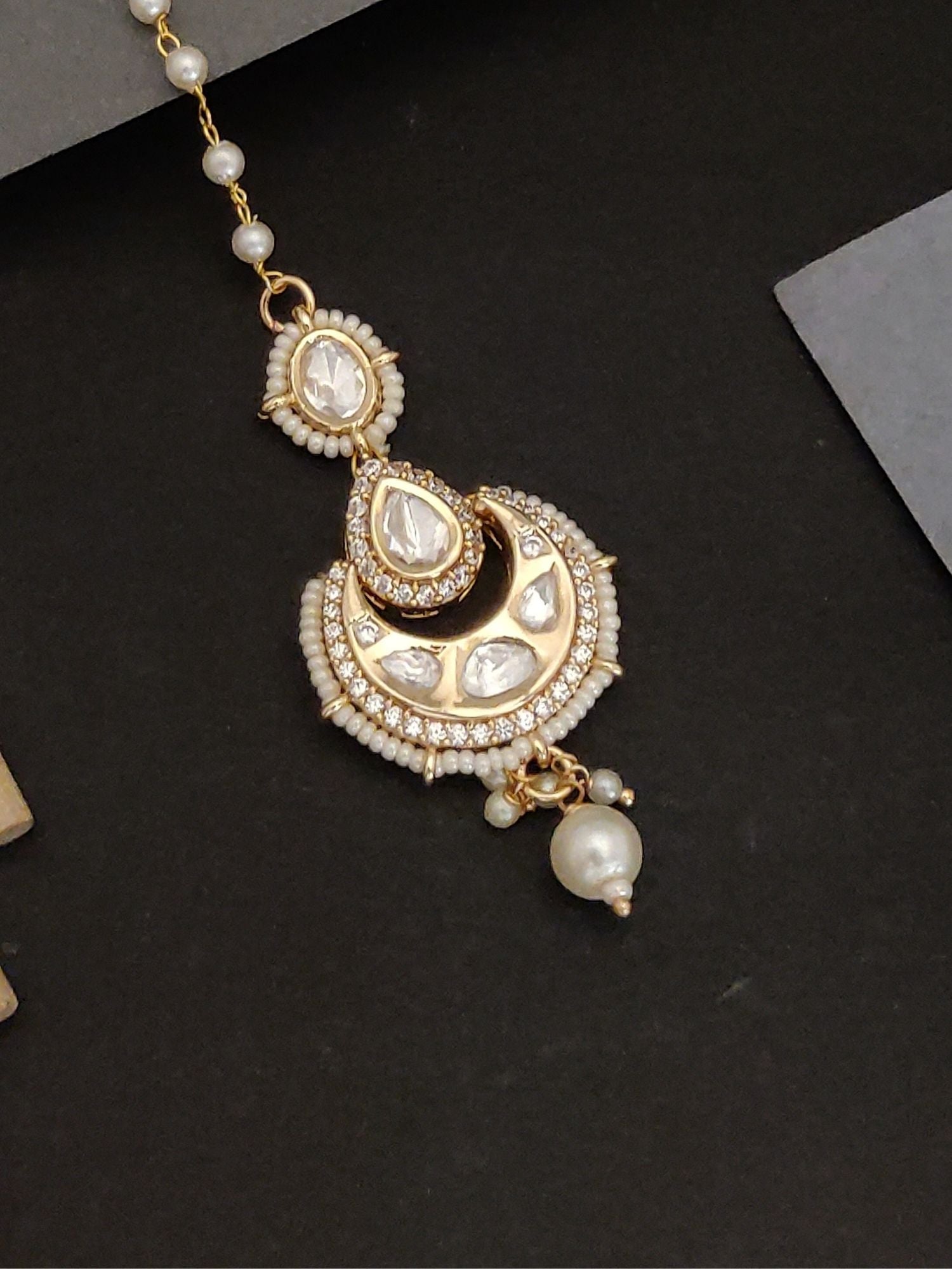 Gold plated bridal polki maangtikka with white pearls and intricate stone detailing