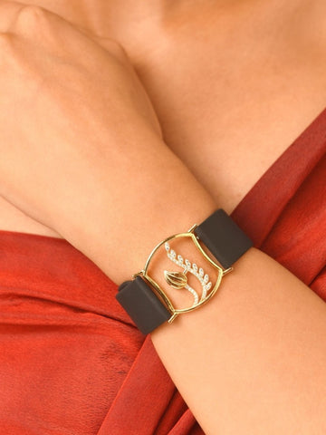 Abdesignsjewellery gold plated hand belt bracelet with gold leaf and crystal accents on black leather strap on wrist