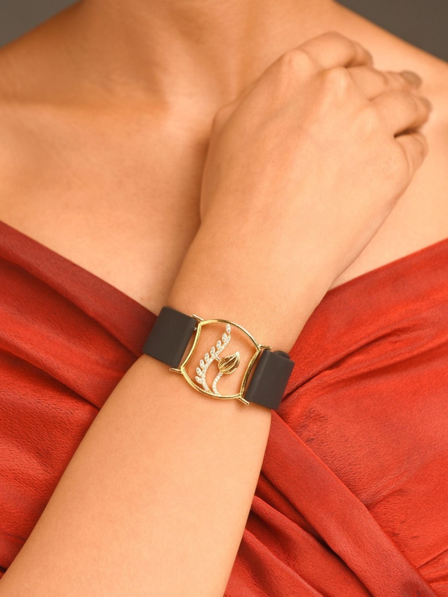 Abdesignsjewellery gold plated hand belt bracelet with black leather strap and gold leaf medallion on wrist