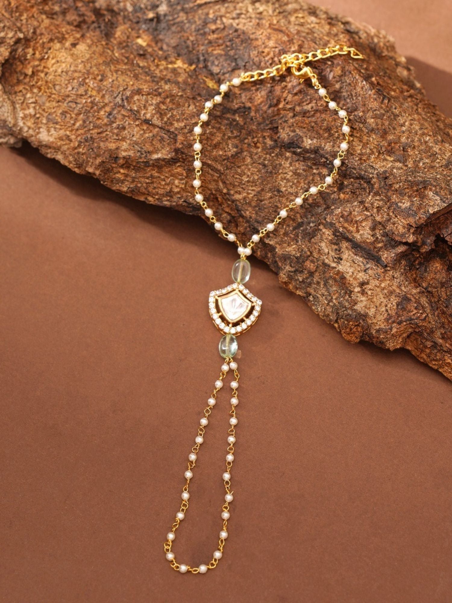 gold plated hand pocha bracelet from Abdesignsjewellery with delicate pearls and teardrop central pendant hand harness