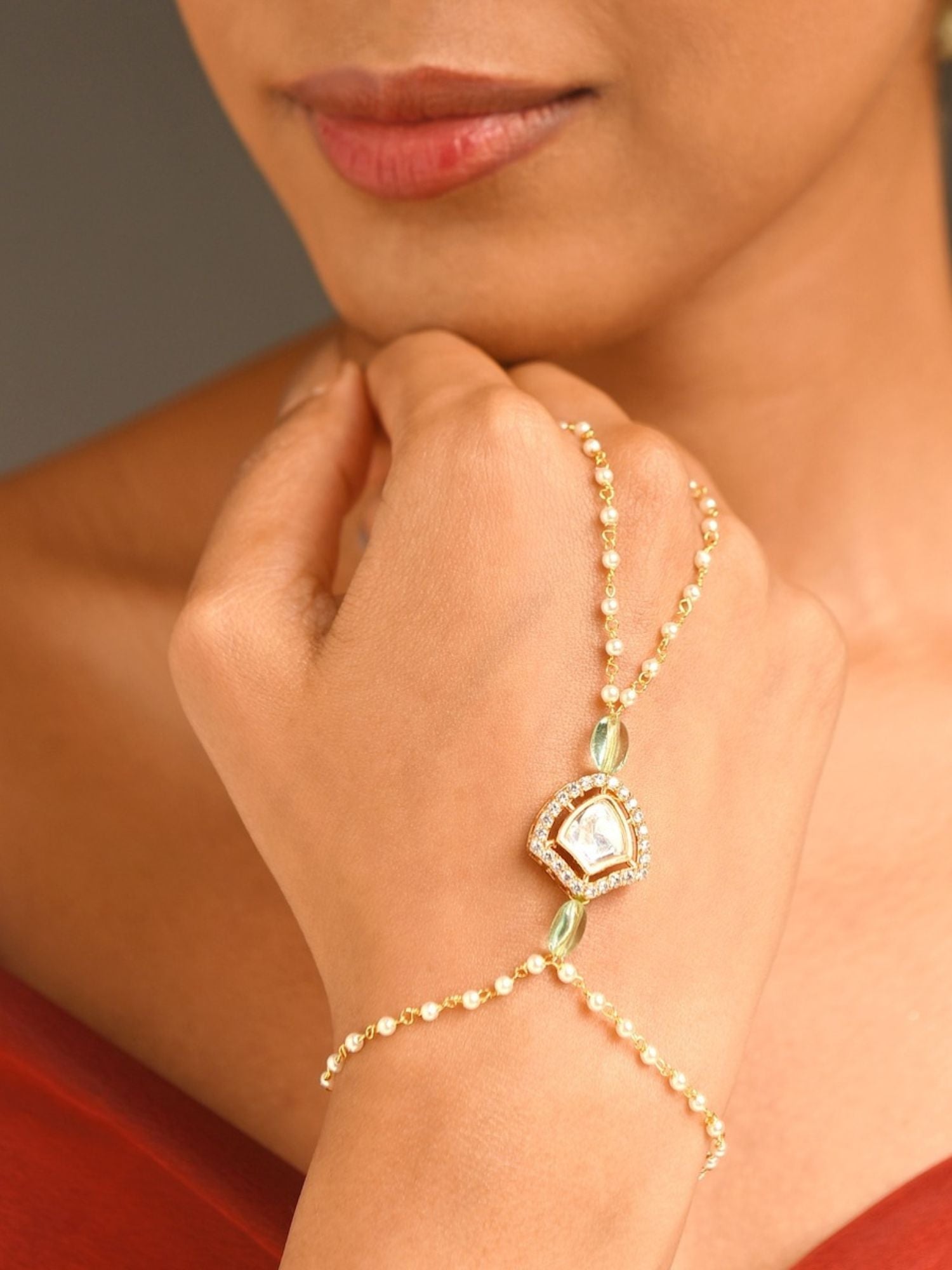 Abdesignsjewellery gold plated hand pocha bracelet with pearls and green stones on model hand