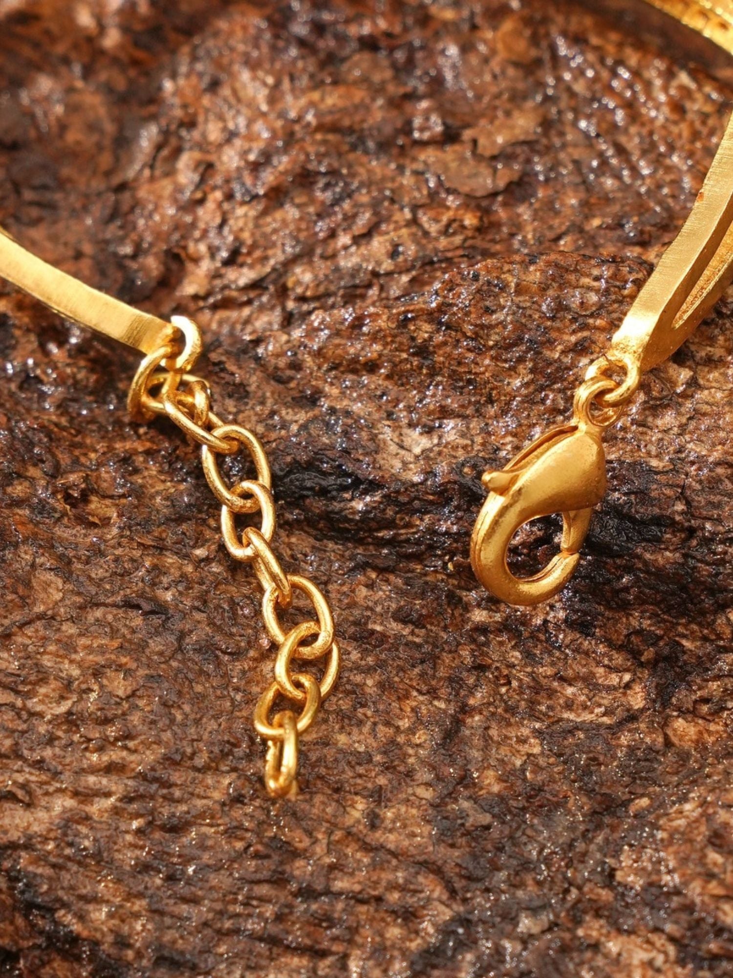 Abdesignsjewellery gold plated mother of pearl bracelet close up showing lobster clasp and extender chain on textured background