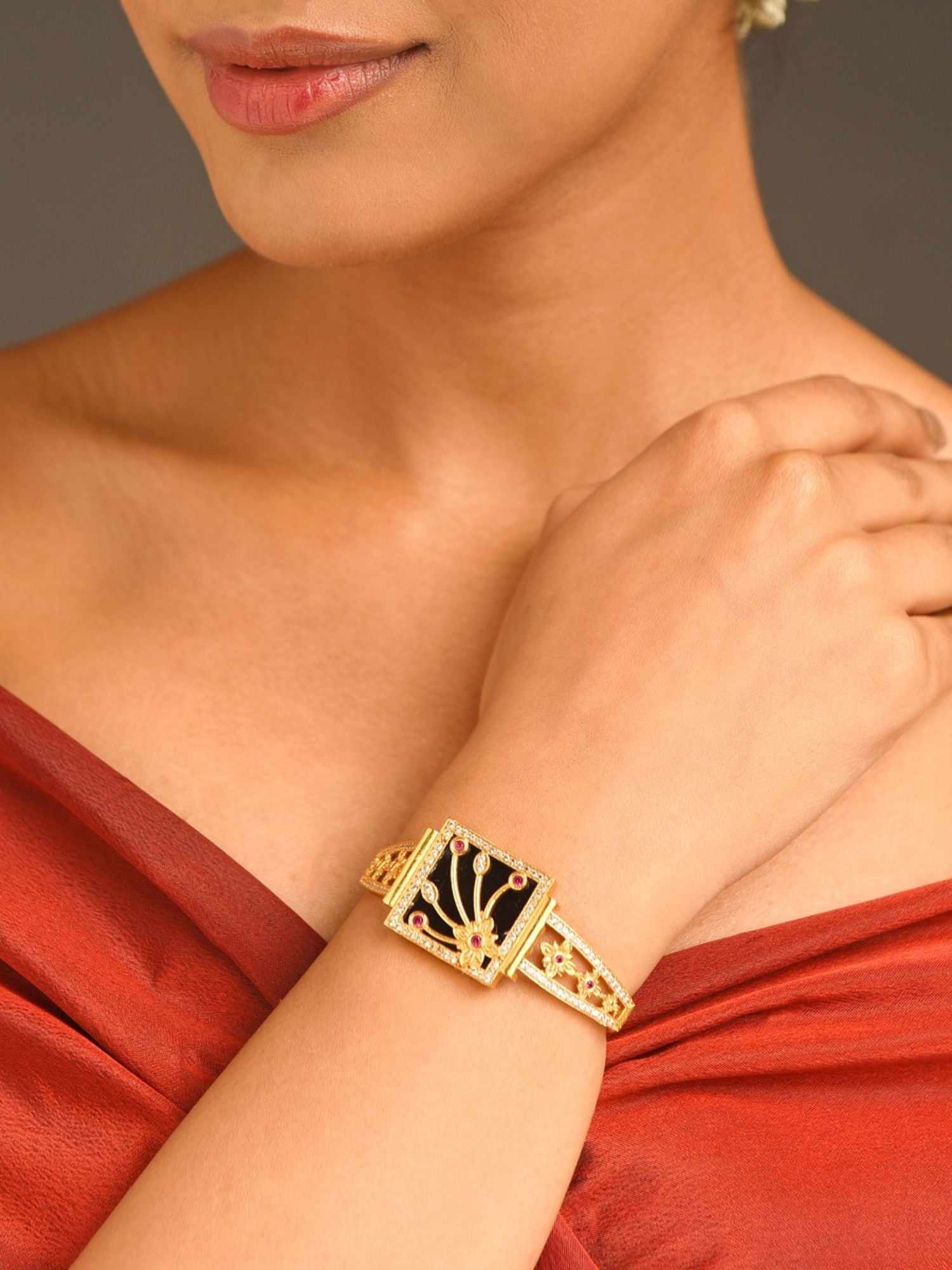 Abdesignsjewellery gold plated mother of pearl bracelet with square decorative centerpiece worn on wrist with red dress