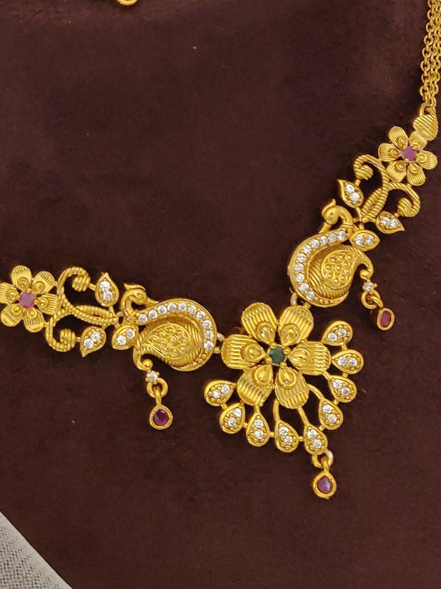 Abdesignsjewellery Gold Plated Peacock Necklace Set with floral peacock pendant and crystal and ruby accents