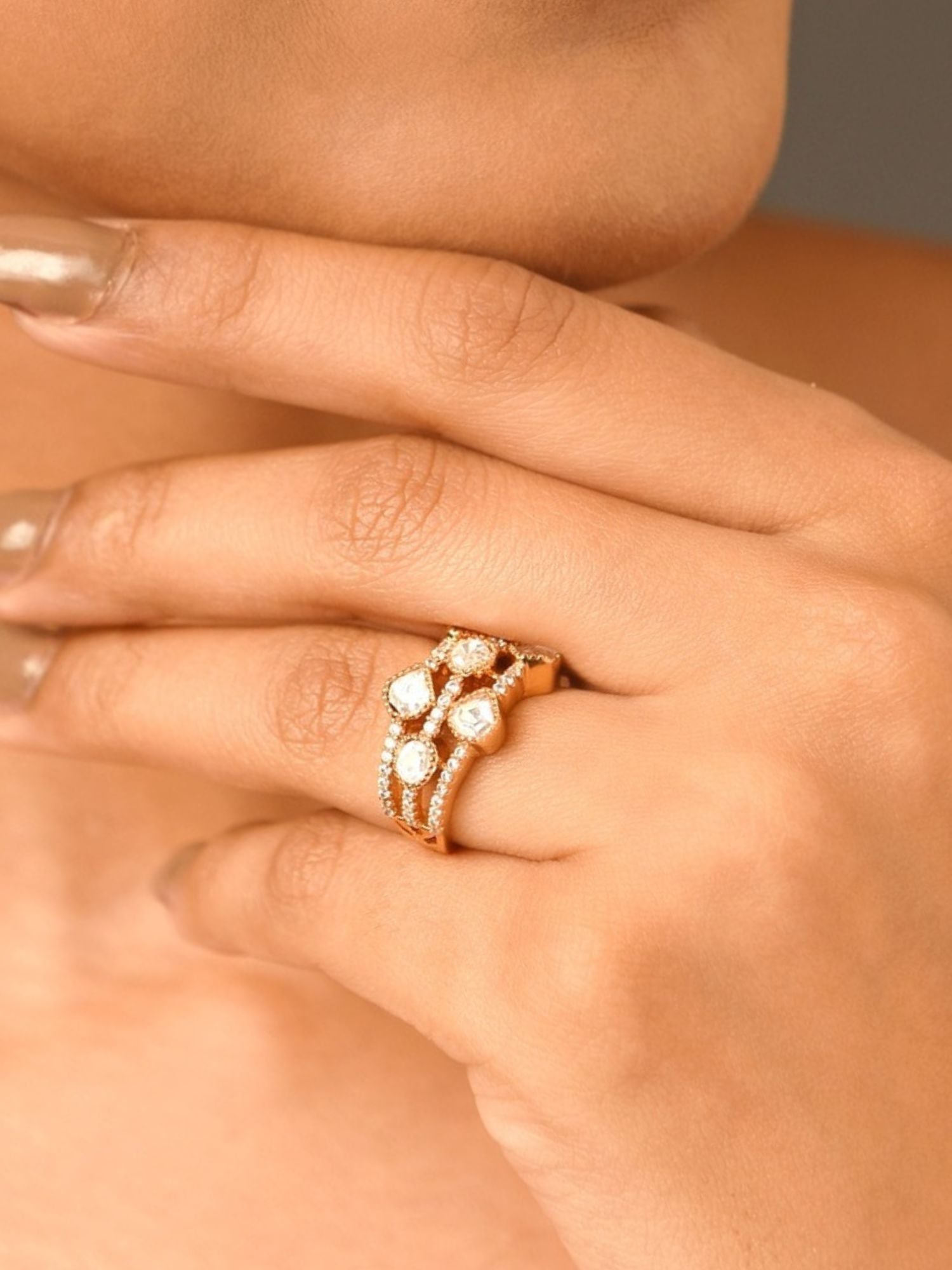 Close up of hand wearing Abdesignsjewellery gold plated polki kundan ring set with three stacked rings
