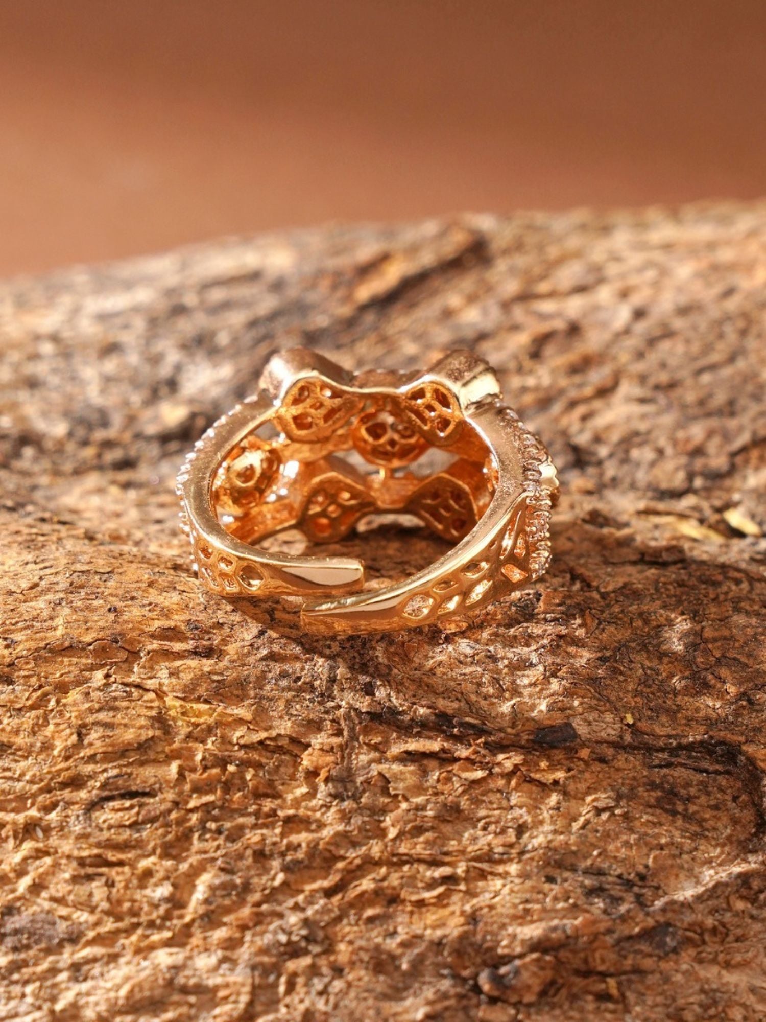 Abdesignsjewellery gold plated polki kundan ring showing ornate filigree band and carved underside on rustic wood