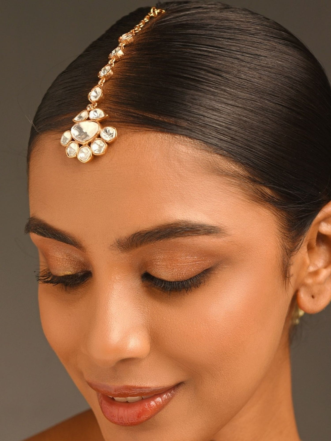 Abdesignsjewellery gold plated polki maangtikka with floral pendant on model with sleek center part hair