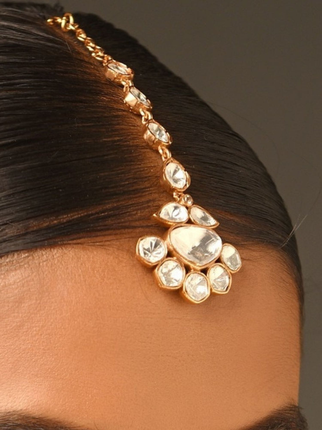 Abdesignsjewellery gold plated polki maangtikka with floral pendant on model with sleek center part hair