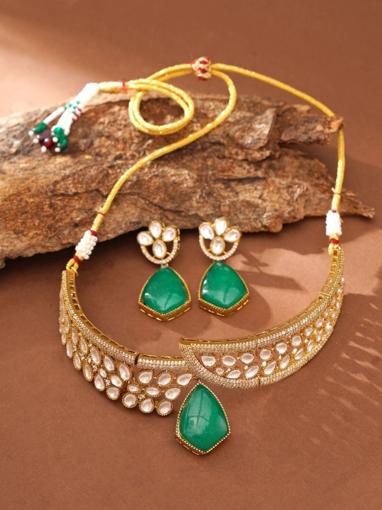 gold plated polki necklace set with green teardrop pendant and matching earrings on gold thread adjustable cord