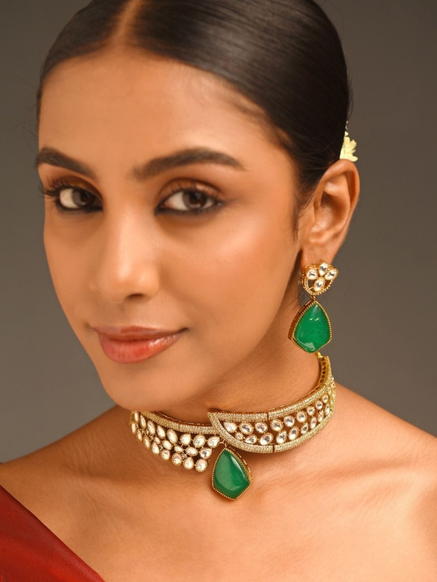 Abdesignsjewellery model wearing gold plated polki necklace set choker with green teardrop stone and matching earrings