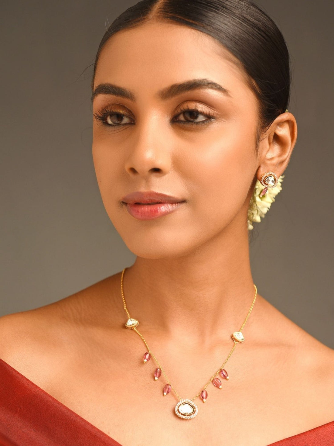 Model wearing Gold Plated Polki Pendant Chain With Earrings with teardrop pendant and matching polki studs