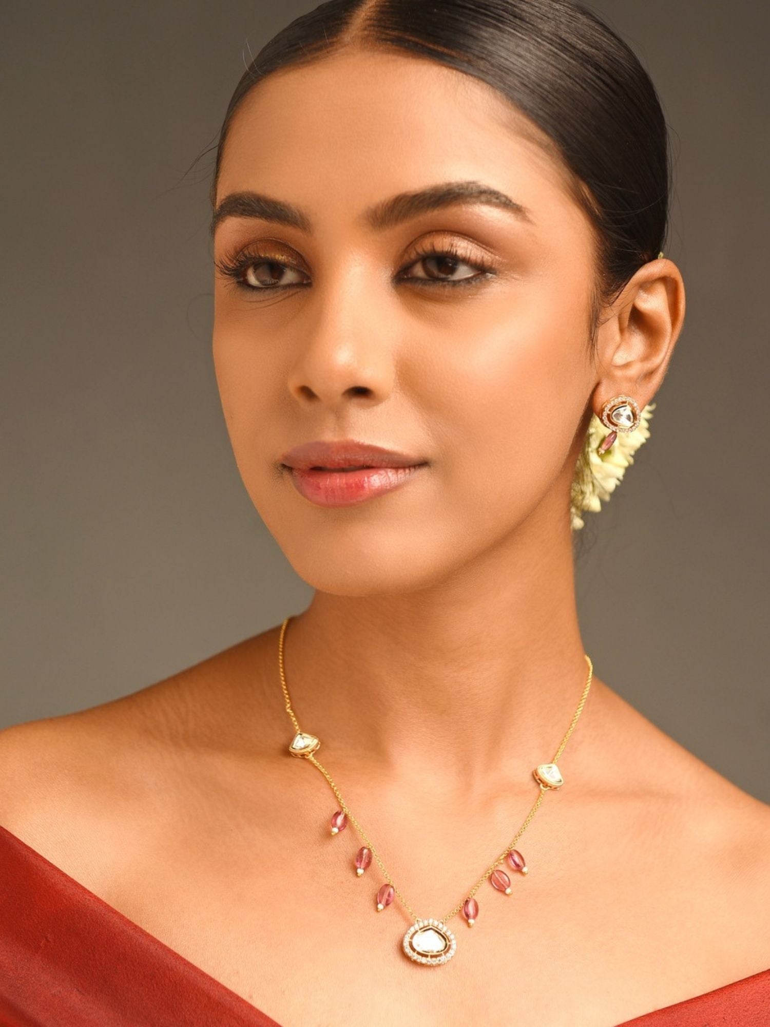 Model wearing Gold Plated Polki Pendant Chain With Earrings with teardrop pendant and matching polki studs