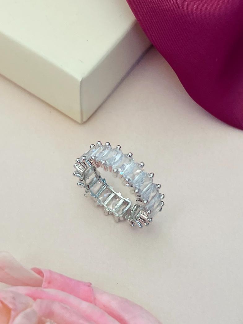 Abdesigns Jewellery Blue Stone Silver Ring for Women displayed on a light surface with a pink cloth and flower