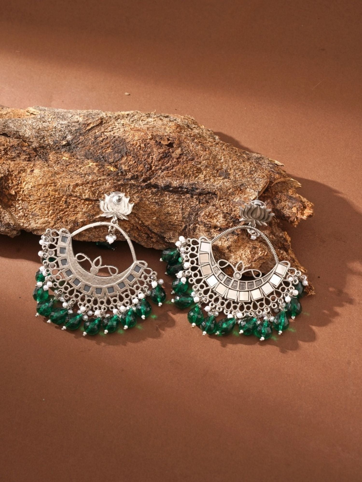 Abdesigns Jewellery Celebrity Style Silver Plated Chandbali Earrings with green bead accents on brown background