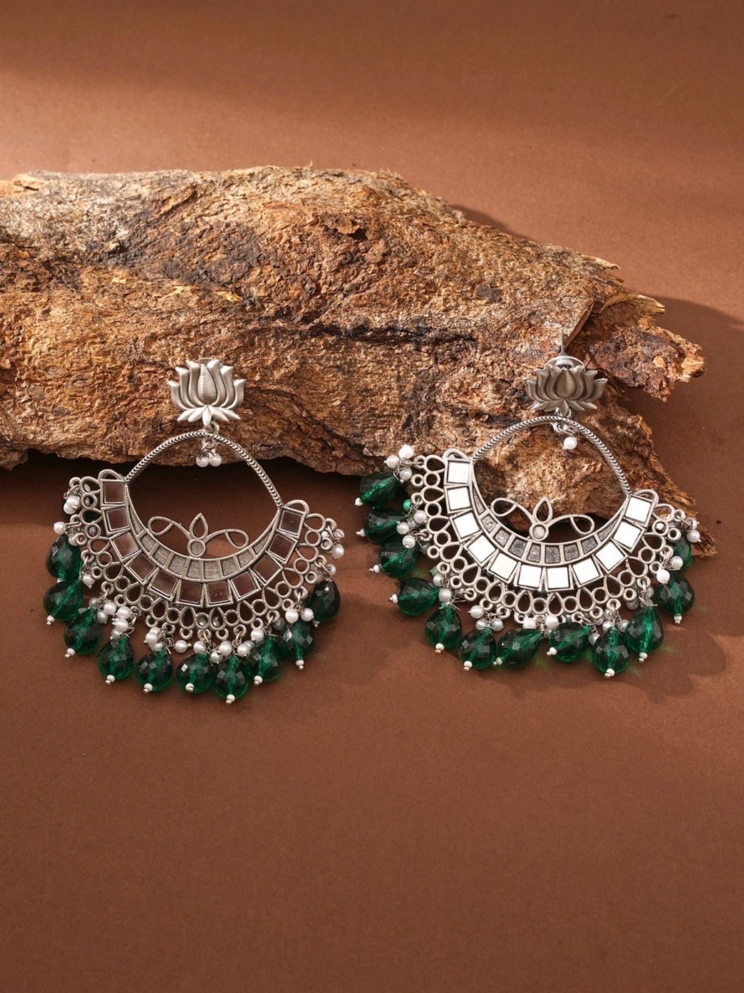Abdesigns Jewellery Celebrity Style Silver Plated Chandbali Earrings with green bead accents on a rustic background