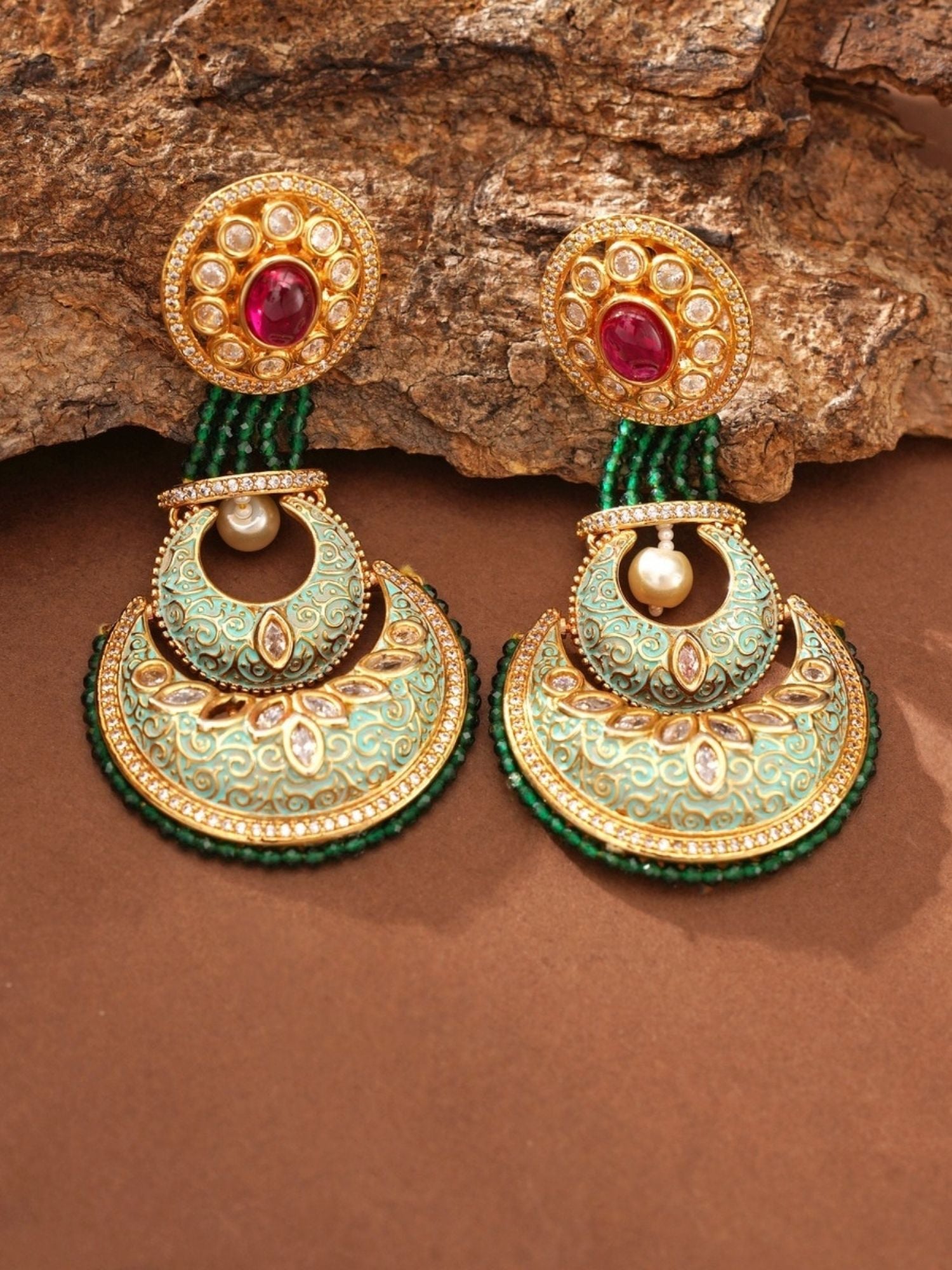 Abdesigns Jewellery Elegant Green Ruby Earrings with gold detailing and pearl accents on a brown background