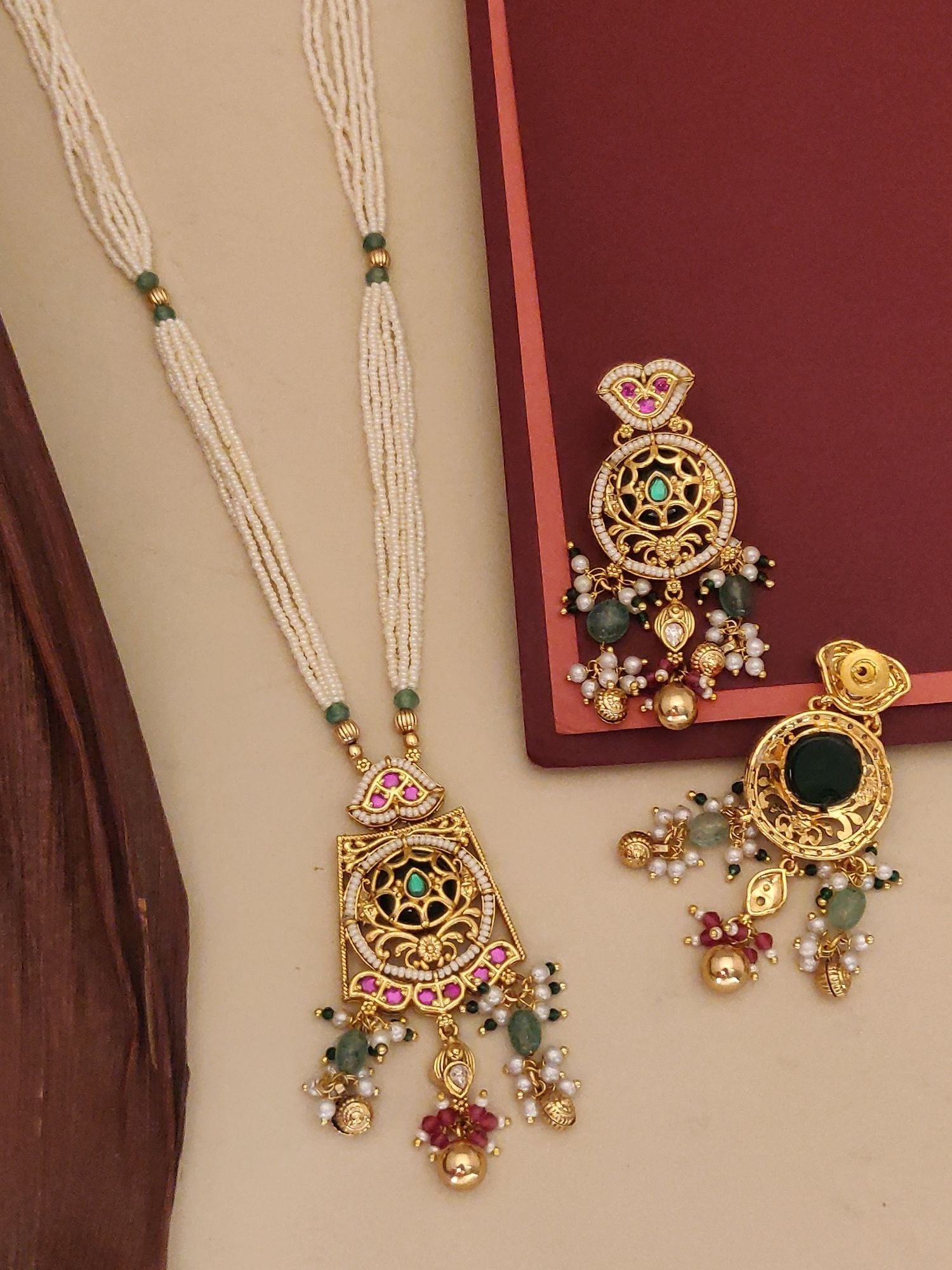 Abdesigns Jewellery Elegant Multi-Strand Pearl Necklace with intricate gold pendant and colorful gemstone accents