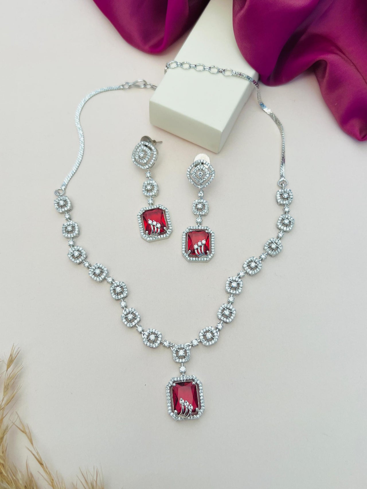 Abdesigns Jewellery Elegant Necklace with Blue Pendant Set featuring silver chain and red gemstone pendant with matching earrings