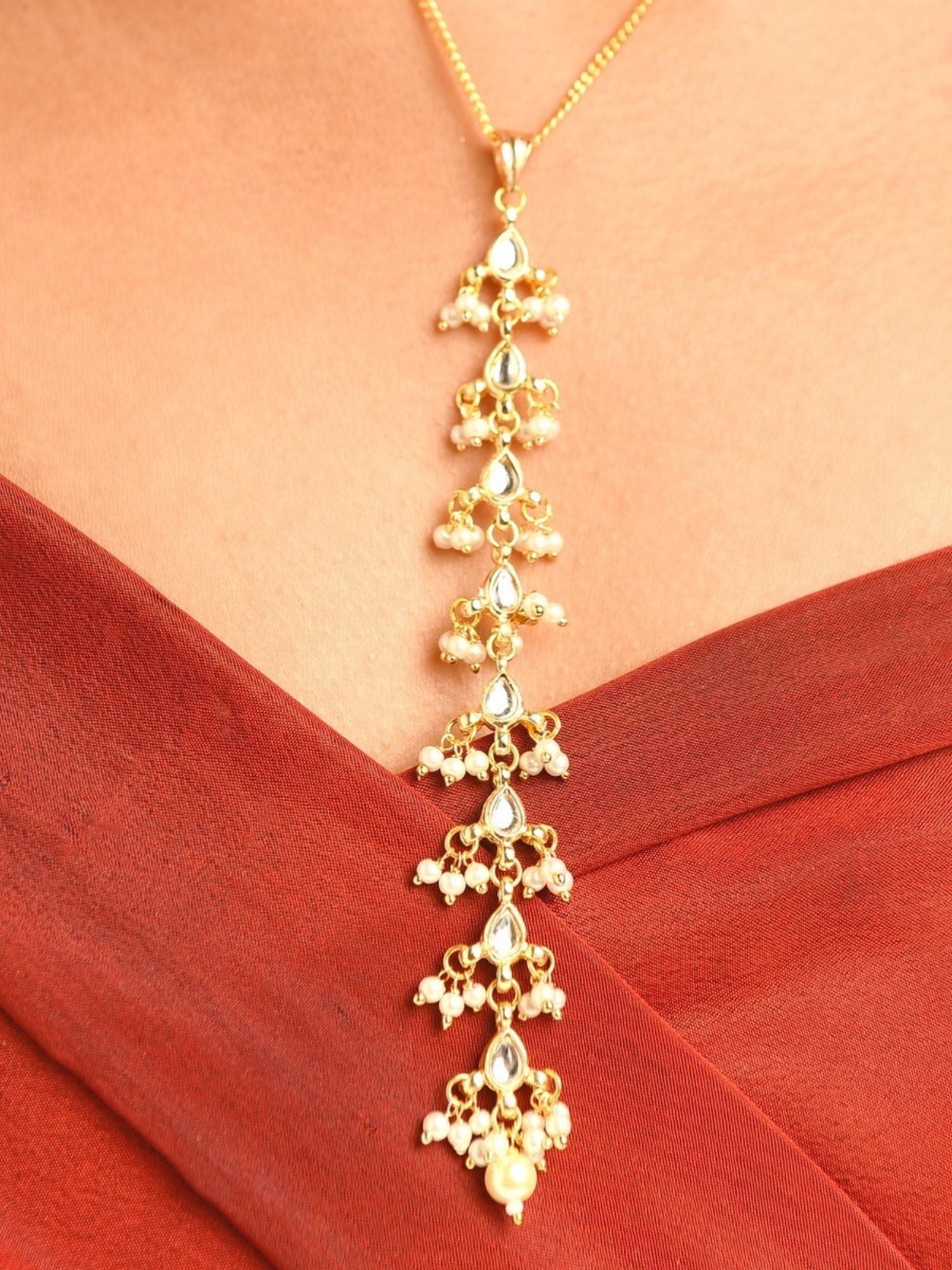 Abdesigns Jewellery Elegant Pendant Chain with Floral Design in gold worn on neck with red outfit