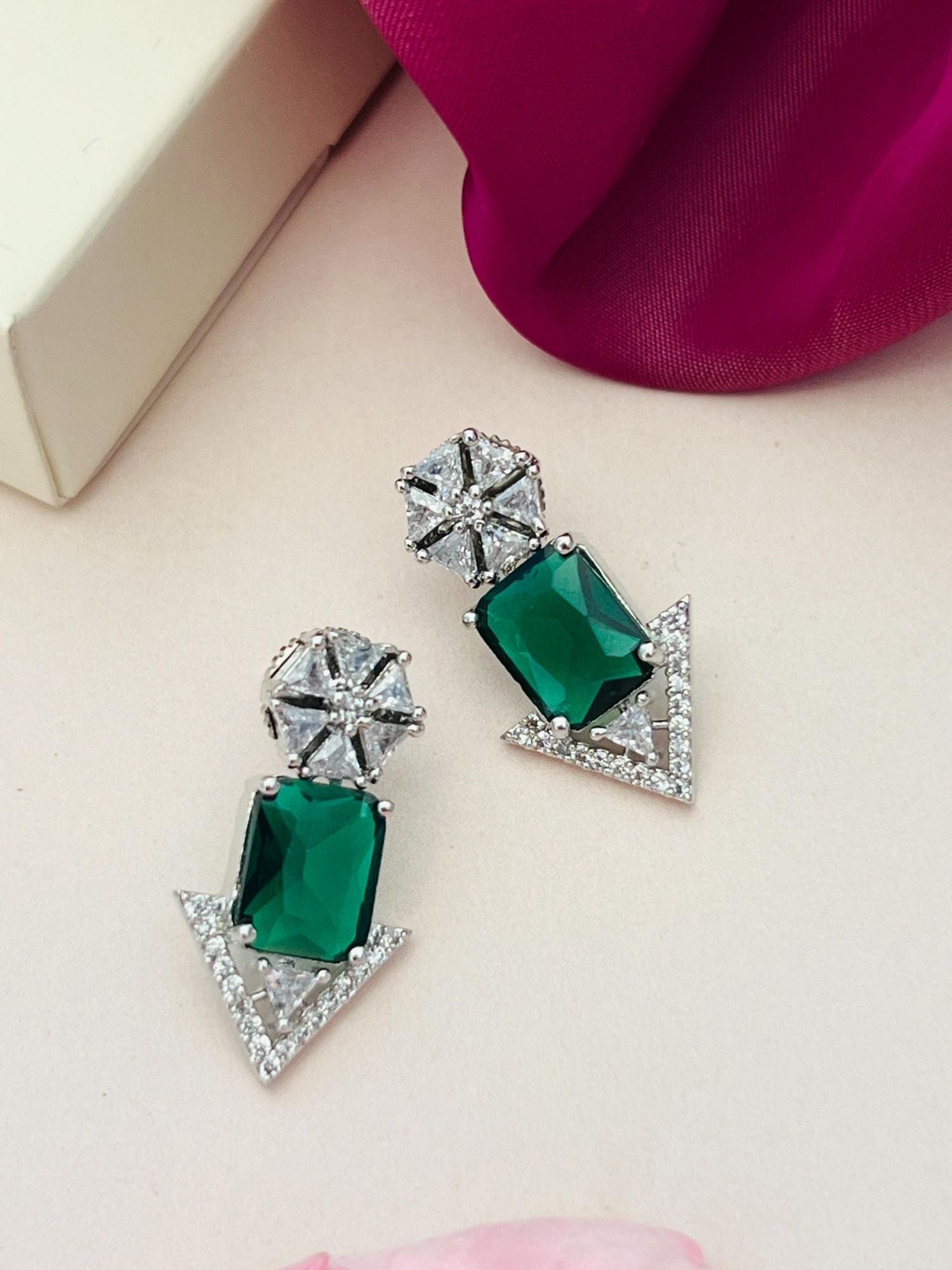 Abdesigns Jewellery Green Stone Arrow Earrings with silver accents and clear crystals on a neutral background
