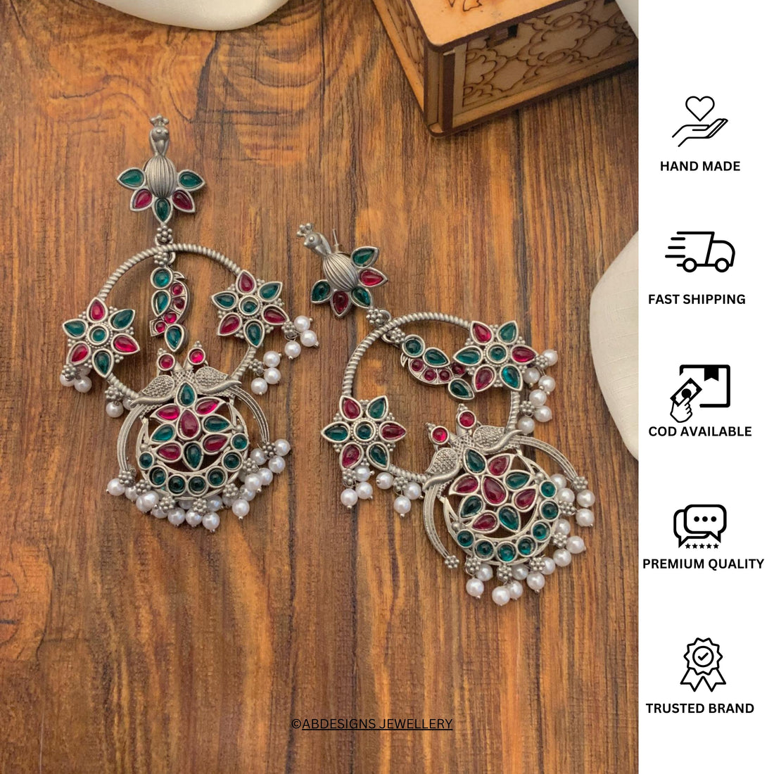 Abdesigns Jewellery Pearl Drop Earrings with Floral Design worn by woman showcasing intricate green and red floral patterns