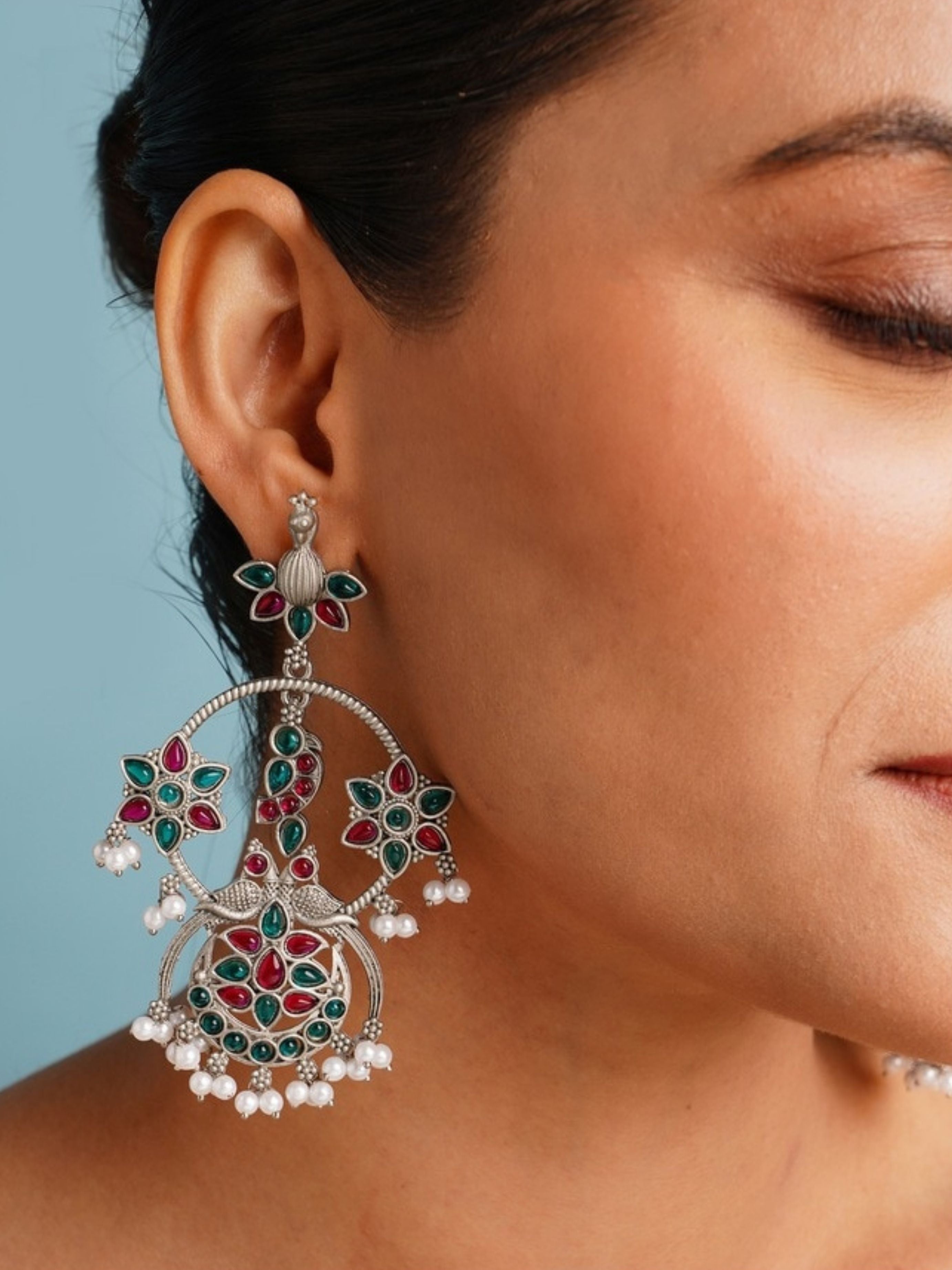 Close-up of Abdesigns Jewellery Pearl Drop Earrings with Floral Design worn on ear