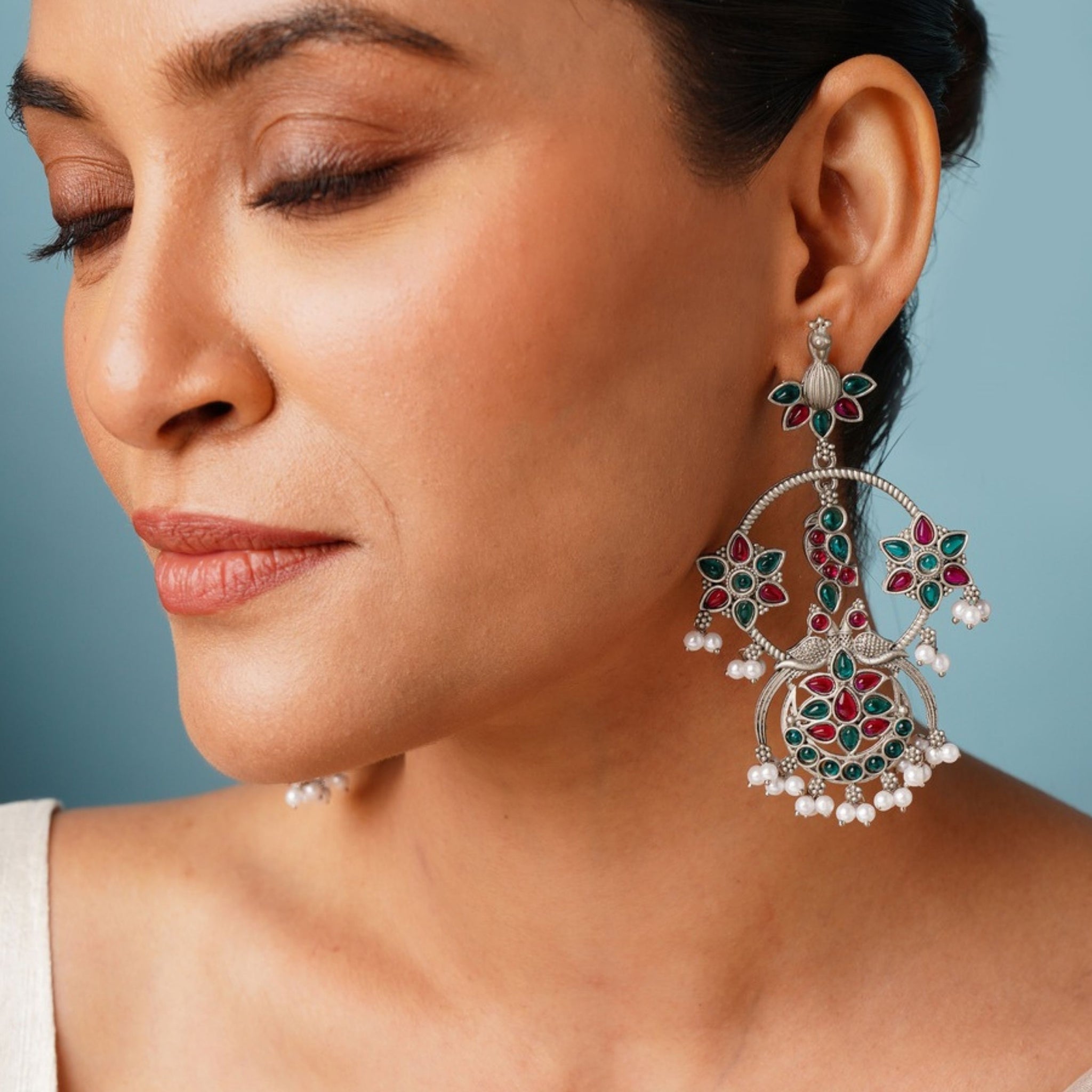 Abdesigns Jewellery Pearl Drop Earrings with Floral Design worn by woman showcasing intricate green and red floral patterns