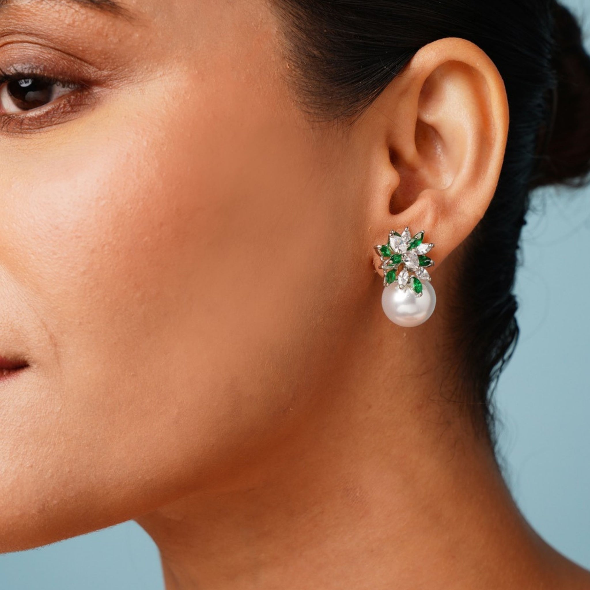 Close-up of a woman wearing Abdesigns Jewellery Pearl & Green Leaf Earrings with pearl drop and green leaf accents