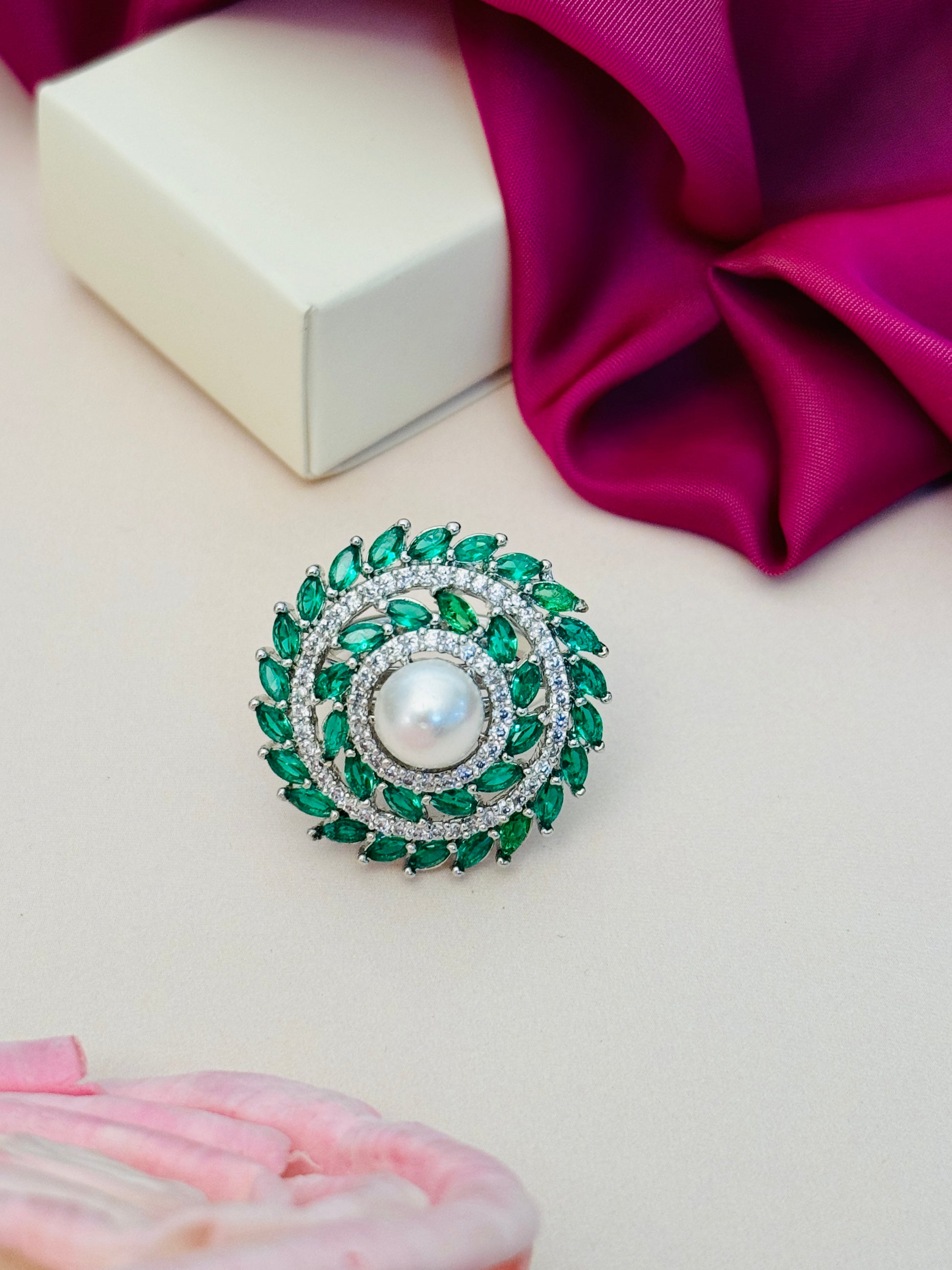 Abdesigns Jewellery Pearl & Pink Stone Silver Ring with green and white stones on beige background