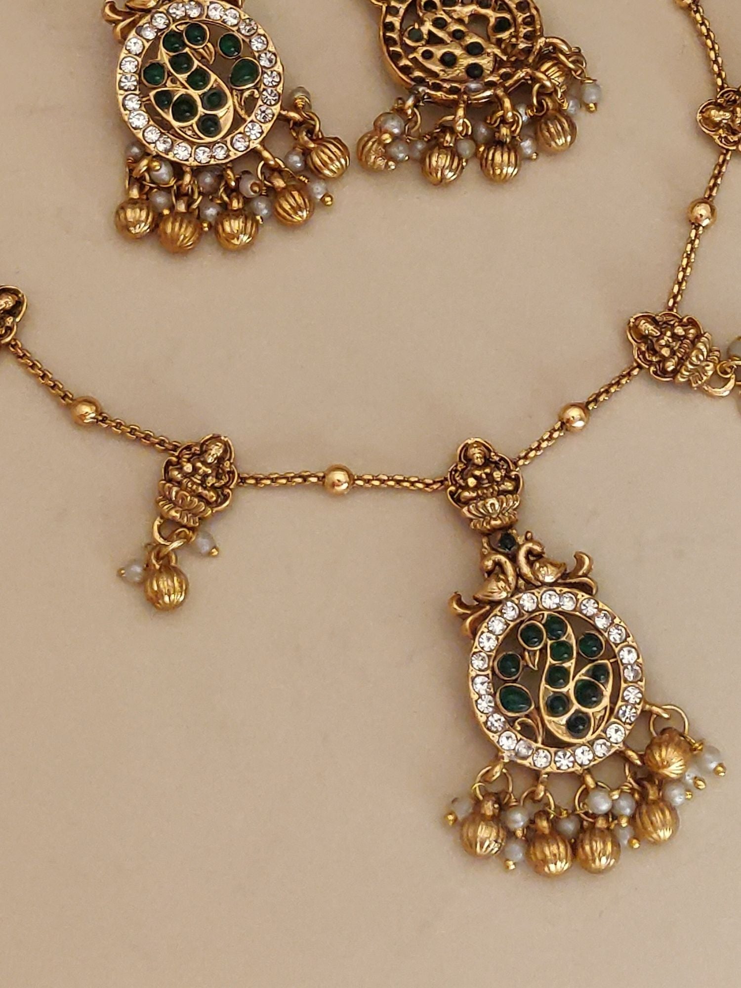 Abdesigns Jewellery Pendents Chain with Antique Gold Finish featuring intricate green and gold designs with dangling beads