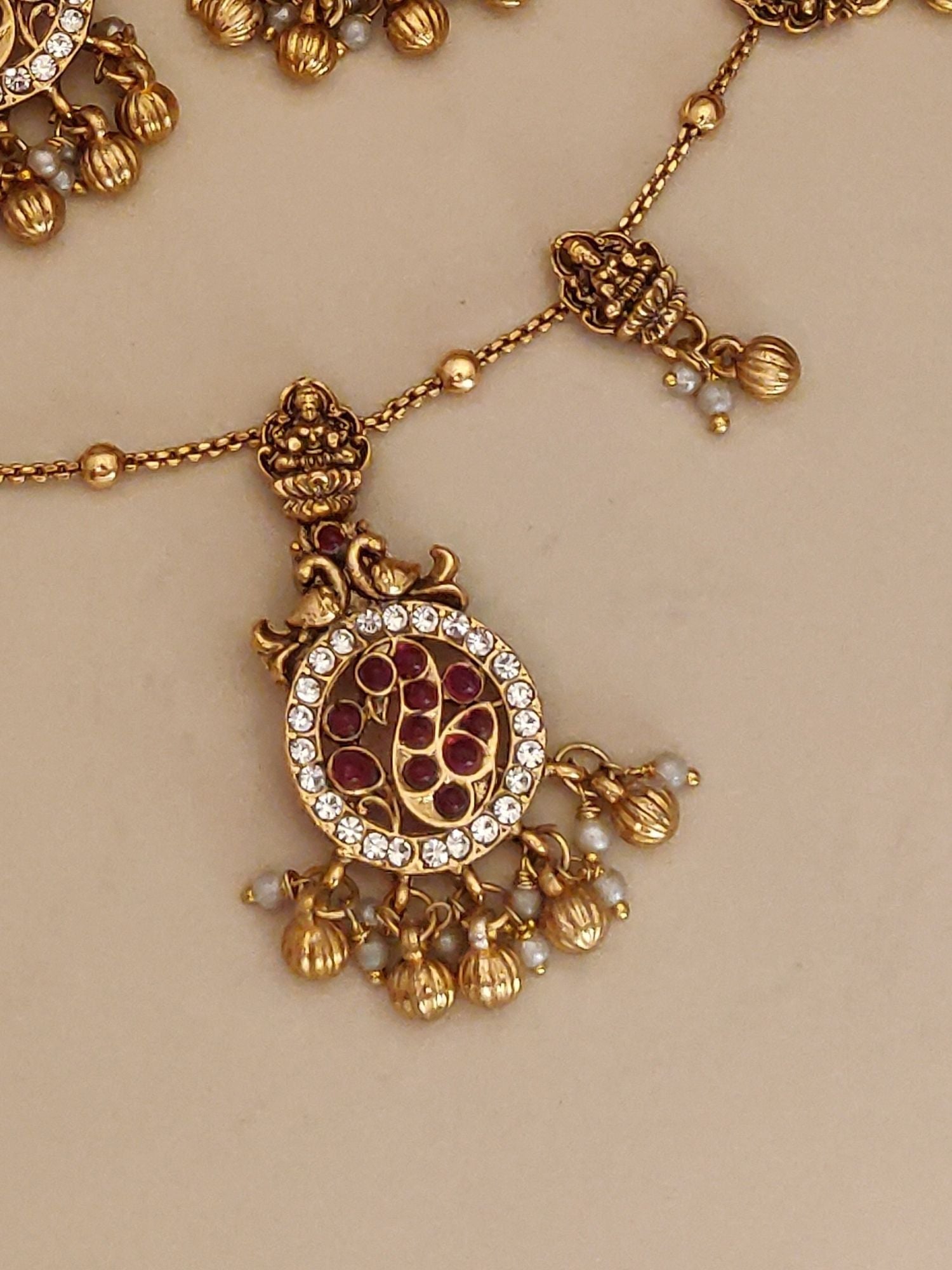 Abdesigns Jewellery Pendents Chain with Antique Gold Finish featuring intricate circular pendant with red and white stones
