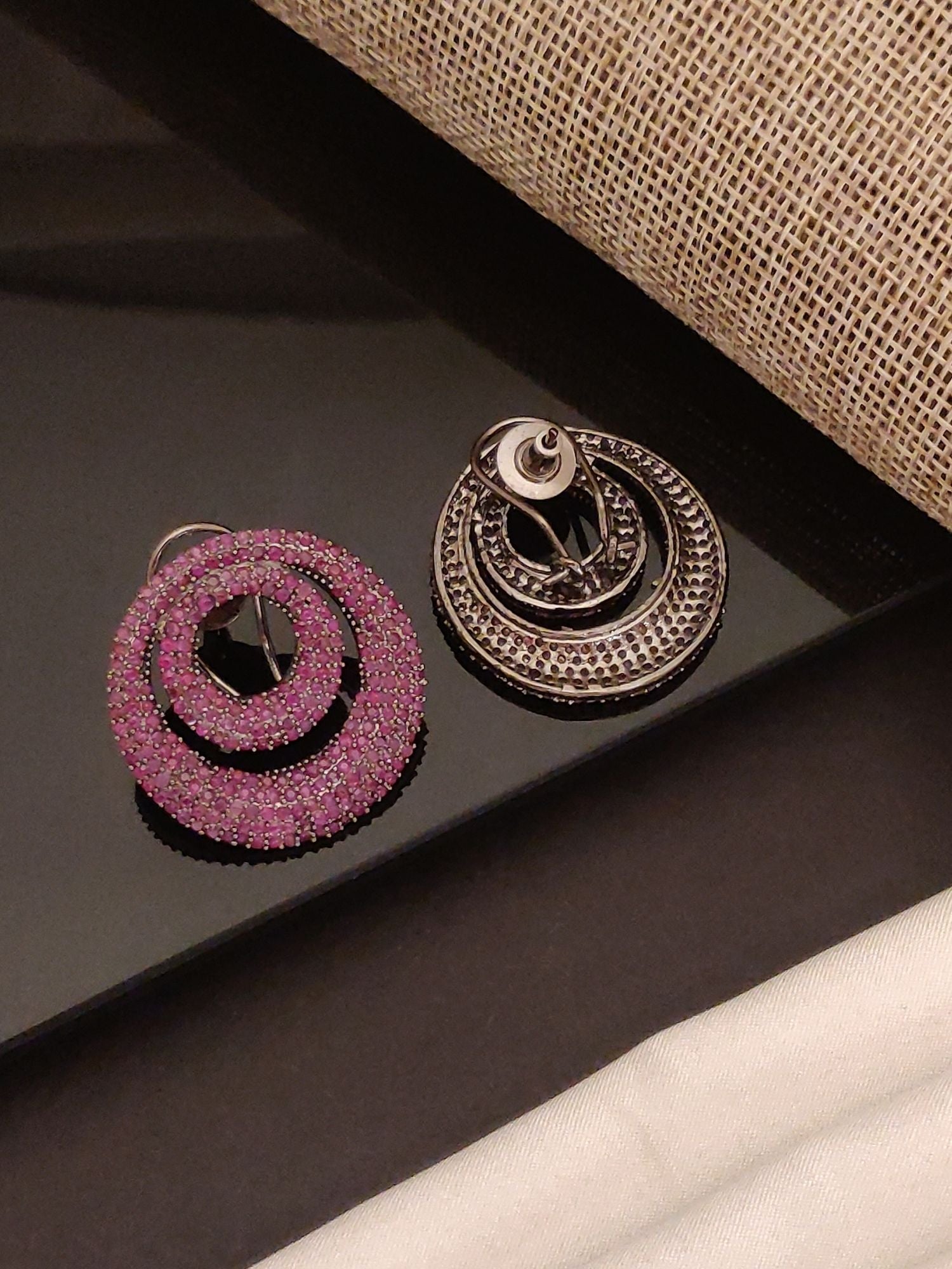 Abdesigns Jewellery Pink Crystal Circle Drop Earrings with sparkling pink crystals on black surface