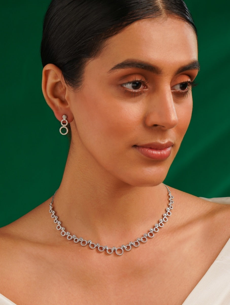 Elegant Abdesigns Jewellery Silver Circle Necklace Set worn by a woman with matching earrings on green background