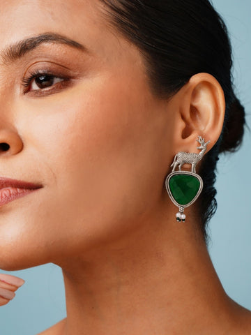 Abdesigns Jewellery Silver Deer Green Stone Earrings worn on woman's ear with detailed deer design
