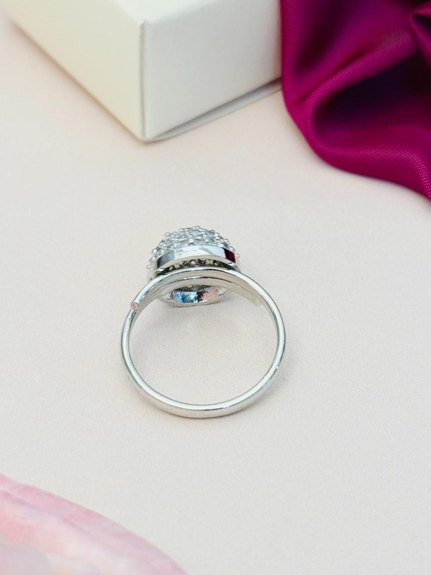 Abdesigns Jewellery Silver Fashion Ring with Stones back view showing silver band and faceted stones on pale surface