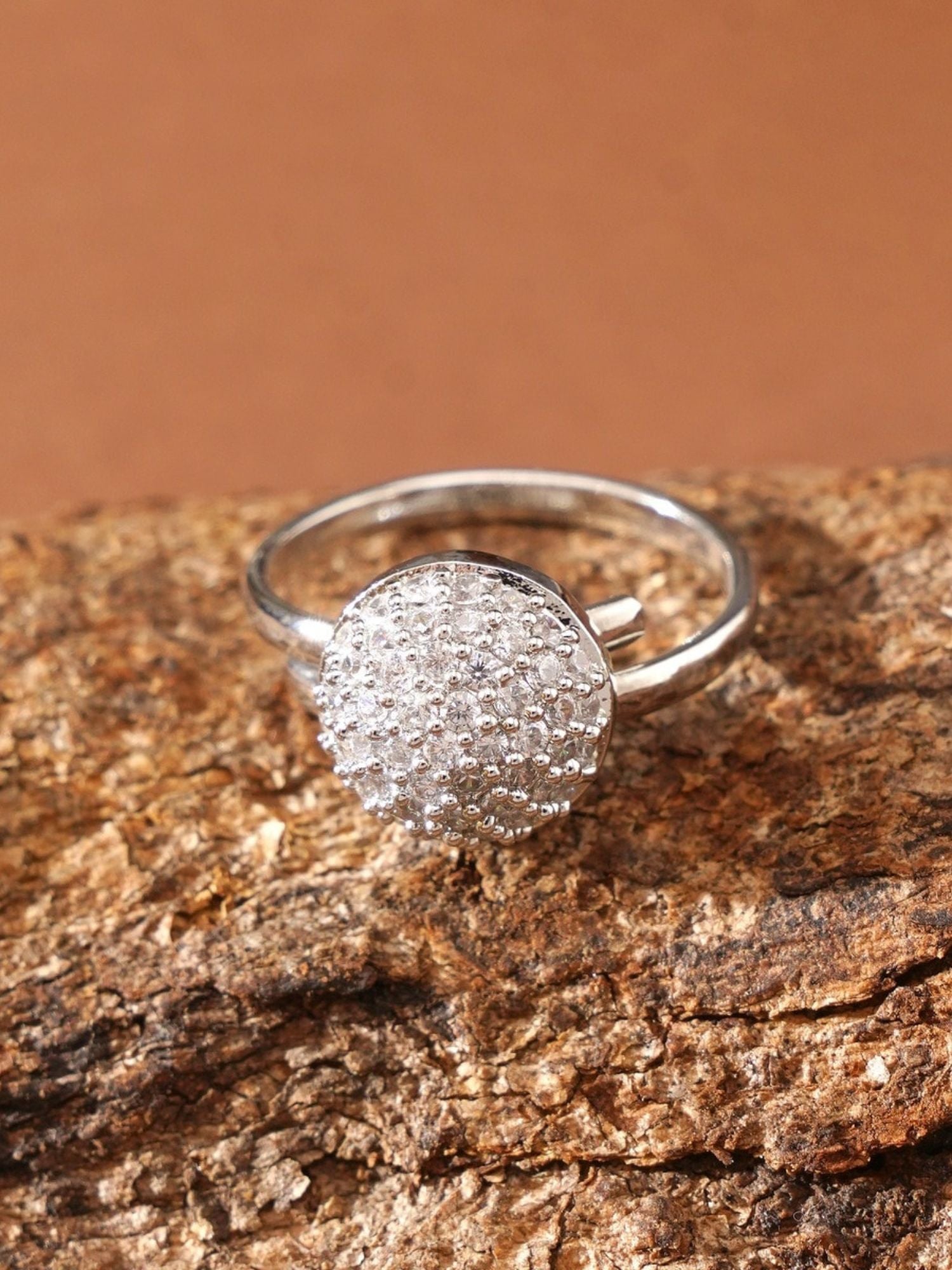 Abdesigns Jewellery Silver Fashion Ring with Stones round pave cluster on sterling band displayed on textured bark background
