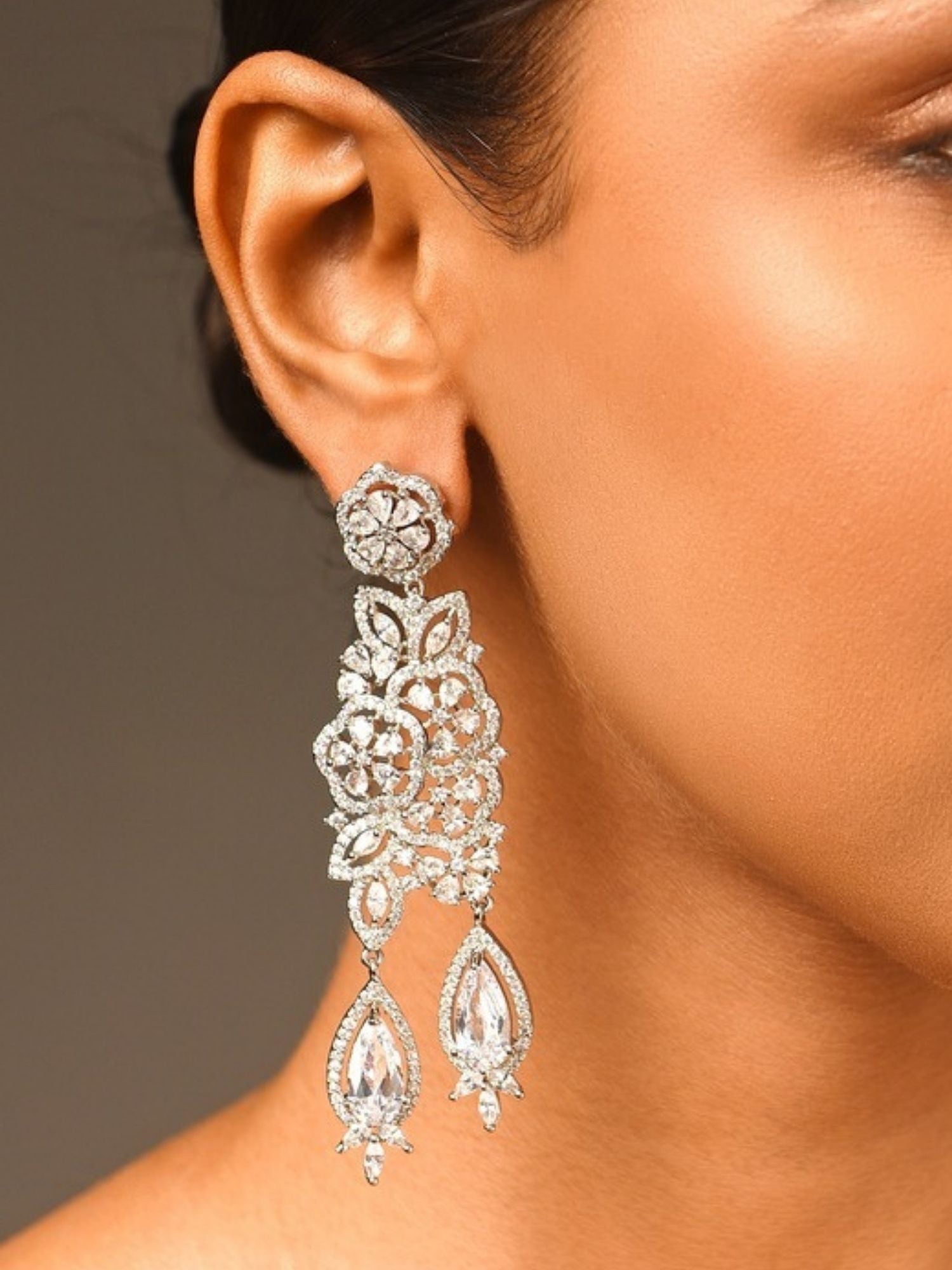 Abdesigns Jewellery Silver Floral Drop Earrings worn on ear with intricate floral design and dangling teardrop crystals